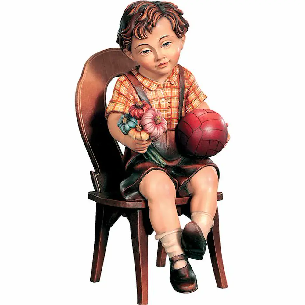 Sitting boy with ball on chair